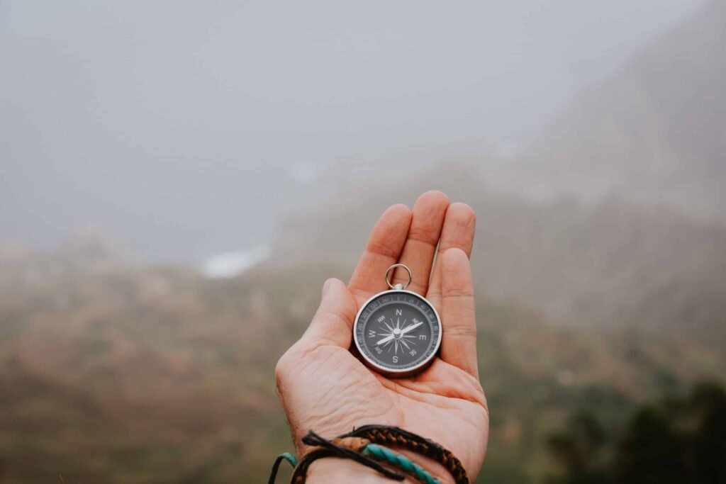 looking at the compass to figure out right direction foggy valley and mountains in bac SBI 327990886 scaled