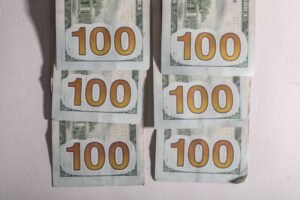 Six stacks of one hundred dollar bills