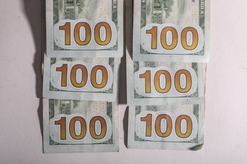 Six stacks of one hundred dollar bills
