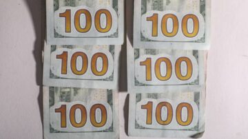 Six stacks of one hundred dollar bills